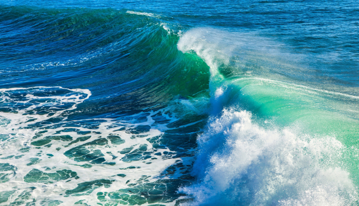 Dramatic wave image in blues and greens.