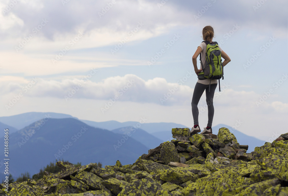 Woman on a mountain enjoying the view.